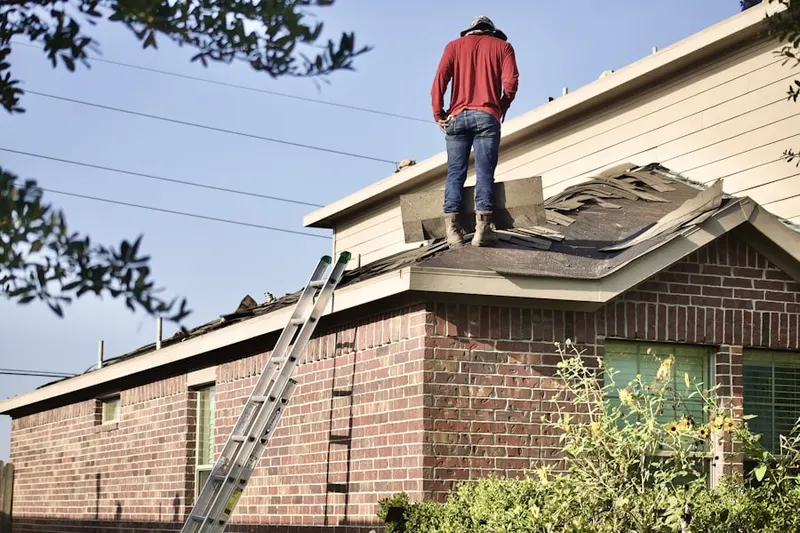 Professional roofer working on a residential roof in Southchase
